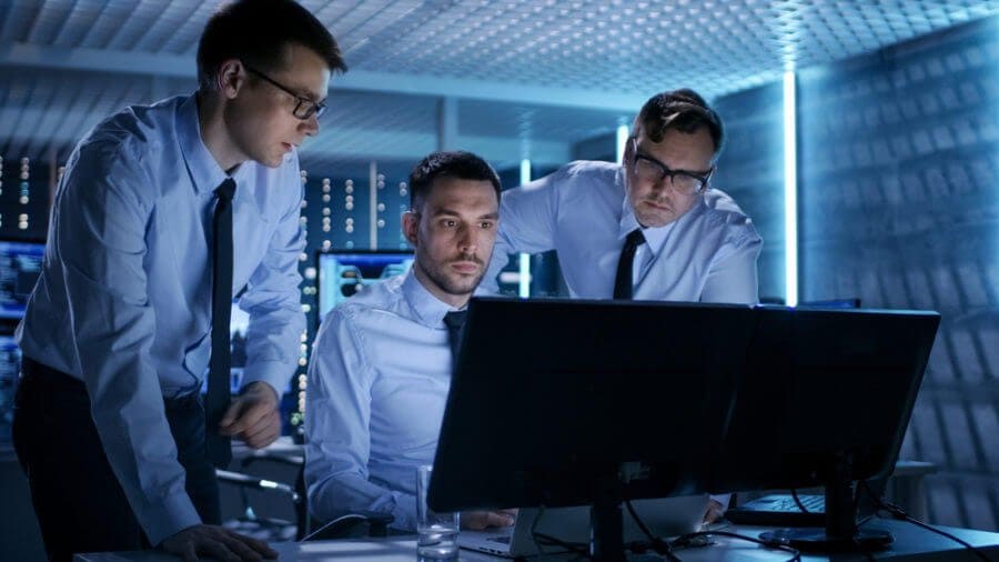 Colleagues looking at computer cybersecurity attack